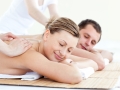 Affectionate couple having a back massage with closed eyes